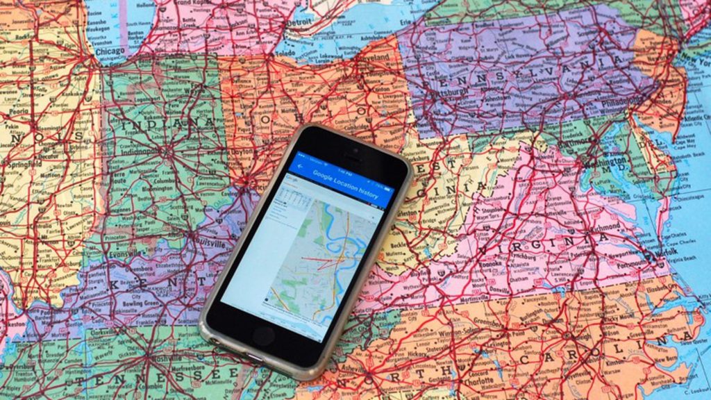 Phone placed on map of the US to represent Google location tracking